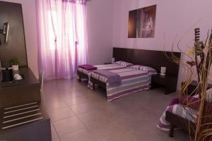 a living room with two beds and a window at Santa Marta in Matera