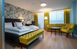 a bedroom with a bed and a couch and a chair at Thon Hotel Slottsparken in Oslo +47 photos