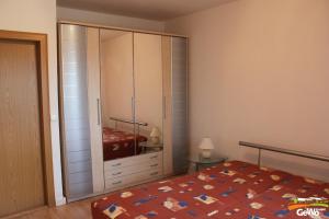 a bedroom with a bed and a large closet at Ferienwohnung August 30 in Gelenau