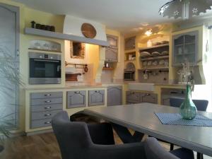 a kitchen with a table and chairs in it at Villa Katarina in Branik