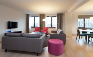 a living room with a couch and chairs and a table at Thon Hotel Slottsparken in Oslo