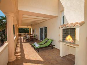 a patio with a fireplace on a house at Villa Calypso - Plusholidays in Calpe