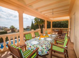 a patio with a table and chairs on a balcony at Villa Calypso - Plusholidays in Calpe