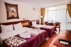 Postel nebo postele na pokoji v ubytování Troia Tusan Hotel + 37 fotografií
