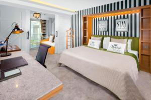 a bedroom with a bed and a desk with a laptop at Selectum Luxury Resort Belek in Belek