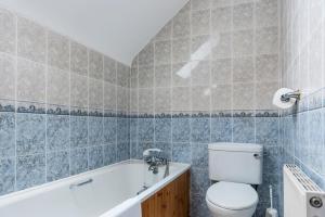 a bathroom with a toilet and a bath tub at Portbeg Holiday Homes at Donegal Bay in Bundoran