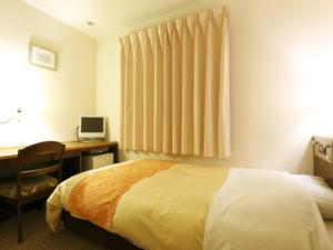 Postel nebo postele na pokoji v ubytování Hotel New Ueno