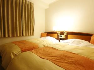 Postel nebo postele na pokoji v ubytování Hotel New Ueno