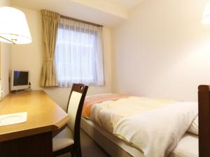 Postel nebo postele na pokoji v ubytování Hotel New Ueno