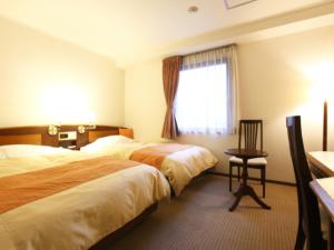 Postel nebo postele na pokoji v ubytování Hotel New Ueno