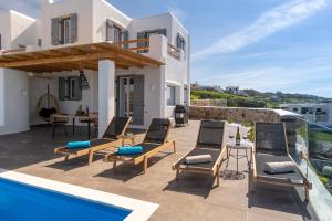 a villa with a swimming pool and a house at NAXIAN SUNSET VILLAS in Naxos Chora