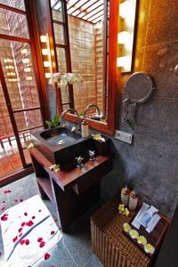 a bathroom with a sink and a mirror at Villa Samudra Luxury Beachfront in Ketewel