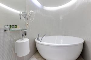 a white bath tub sitting next to a white toilet at Estonia Resort Hotel & Spa in Pärnu
