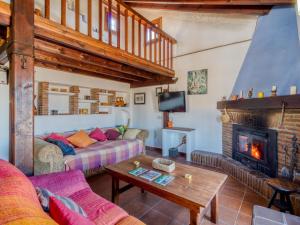 a living room with a couch and a fireplace at Belvilla by OYO La Zamarra in Alcaucín