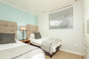 Ένα ή περισσότερα κρεβάτια σε δωμάτιο στο The Apex Rosebank - Building with generator