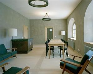a living room with a table and chairs at Ospizio San Gottardo in Airolo