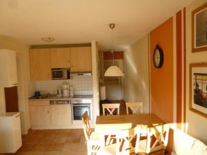 a kitchen with a table and a dining room at Appartementhaus Strandstrasse 16 in Kühlungsborn