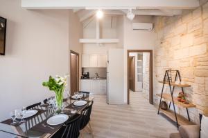 a dining room and kitchen with a table and chairs at Spilia Village Hotel & Villas in Spiliá