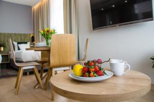 a bowl of fruit on a table in a room at Verde Apartments CENTRUM in Koszalin