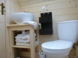 a bathroom with a sink and a toilet at Les cabanes de Kerellou in Plouigneau +11 photos