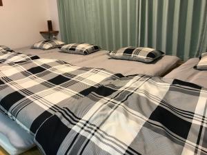 two beds with pillows on them in a bedroom at Rental Villa Luana Waioli in Tomigusuku