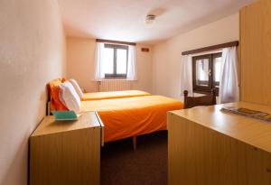 Postel nebo postele na pokoji v ubytování Hotel Meublè Adler - Rooms & Mountain Apartments