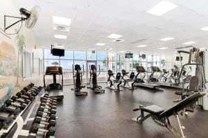 a gym with treadmills and machines in a room at Majestic Sun in Destin
