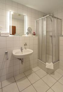 a bathroom with a sink and a shower at Burg Hotel Ziesar in Ziesar