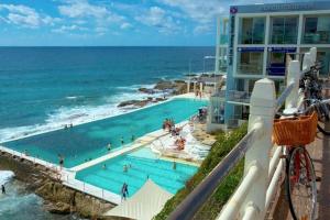 a view of a swimming pool next to the ocean at ULTIMATE BONDI LIVING in Sydney