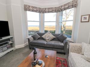 a living room with a couch and a table at Whinstones at 4 The Villas in Alnwick