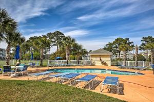 a swimming pool with lounge chairs and a poolvisorvisor at Magnolia Pointe Myrtle Beach Condo on Golf Course! in Myrtle Beach