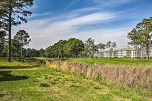 a view of a golf course with trees and buildings at Magnolia Pointe Myrtle Beach Condo on Golf Course! in Myrtle Beach