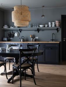 a kitchen with a table and chairs and a sink at INNI - Boutique apartments in Hveragerði