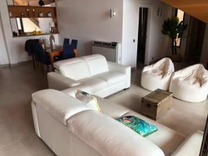 a living room with two white couches and a table at Beach Apartment Marina Vilamoura in Vilamoura