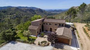 an aerial view of a house with mountains in the background at Finca Son Pol in Andratx
