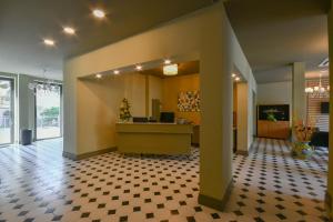 a lobby with a reception desk and a checkered floor at Hotel Residence Paradiso in Moneglia