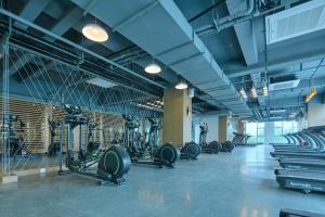 a gym with rows of treadmills and machines at Holiday Inn Express Luoyang Yichuan, an IHG Hotel in Yichuan