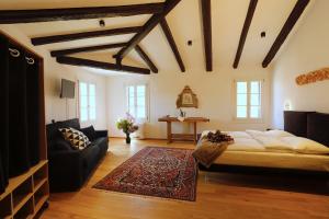 a bedroom with a large bed and a couch at Villa De' Giacomi in Teolo