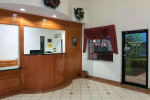 a lobby with a waiting room with a window at Super 8 by Wyndham Stafford Sugarland Area in Stafford