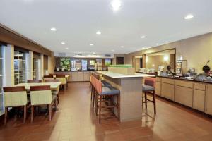 a kitchen with a table and chairs in it at La Quinta Inn & Suites by Wyndham LV Tropicana Stadium in Las Vegas