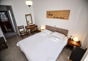 a bedroom with a bed and a mirror on the wall at Κastro Ηotel in Agios Kirykos