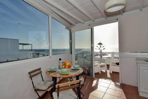 a dining room with a table and chairs and large windows at Top Sea Views in El Golfo Prime location By PVL in El Golfo