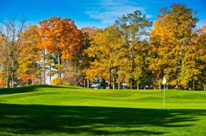 a golf course in the fall with trees at Candlewood Suites East Lansing, an IHG Hotel in Lansing