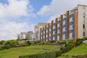 a large building with a lawn in front of it at Beach View in St Ives