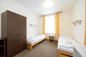 Postel nebo postele na pokoji v ubytování Penzion Vědomice