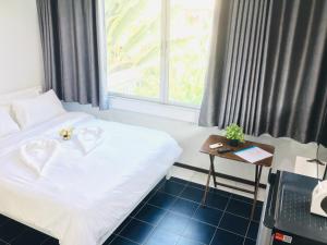 a hotel room with a bed and a window at NK Guesthouse 2 in Bangkok