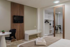 TV a/nebo společenská místnost v ubytování Citi Hotel Residence Caruaru