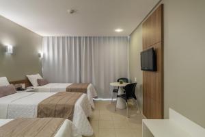 Postel nebo postele na pokoji v ubytování Citi Hotel Residence Caruaru + 26 fotografií