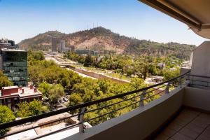 a balcony with a view of a city at Chilean Suites and Apartment in Santiago