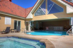 a swimming pool in the backyard of a house at Tranquil Waterfront Condo in Kelowna